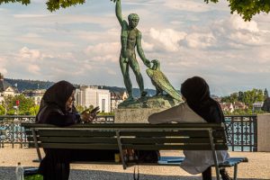 Kopftuchträgerinnen entspannen vor der Ganymed Skulptur auf der Bürkliterrasse in Zürich / © Foto: Georg Berg