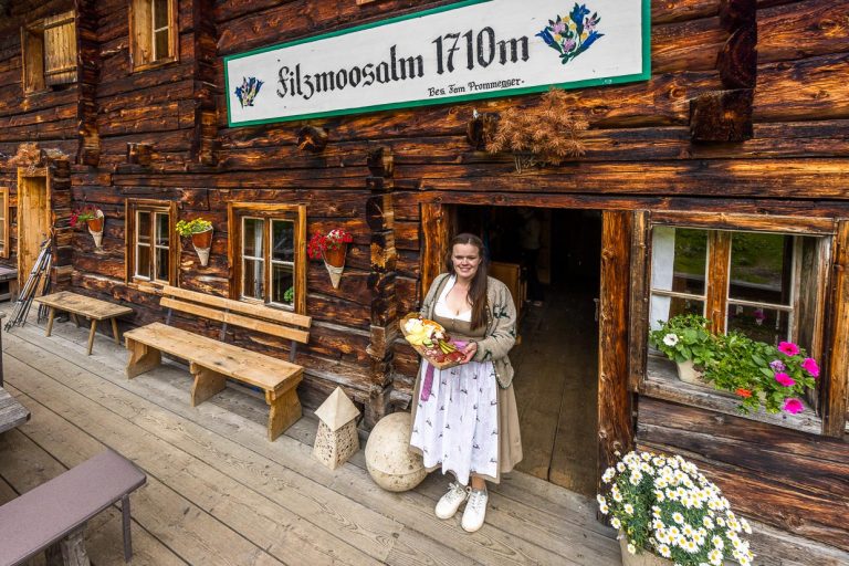 Bäuerin, Käserin und Almwirtin in einer Person. Bettina Huber mit einer Jausenplatte im Eingang der Filzmoosalm. Aus der Milch von 10 Pinzgauer Kühen stellt sie eine Vielzahl an Milchprodukten her, darunter Butter, Buttermilch, Joghurt, Molkedrinks, Sauerkäse und Schnittkäse / © Foto: Georg Berg