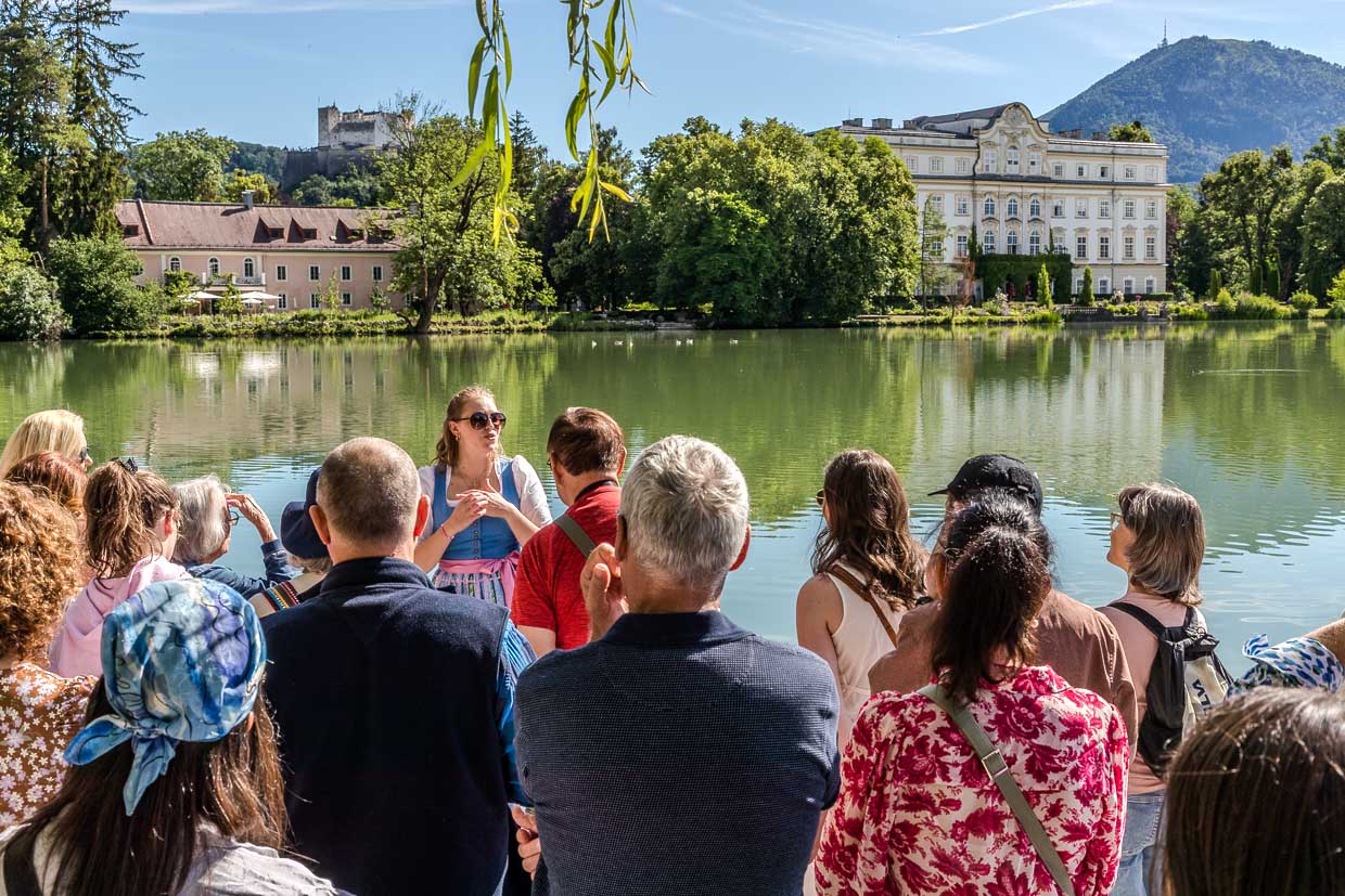 Eine Reiseführerin erklärt einer Gruppe Touristen die Umgebung an der König-Ludwig-Straße in Salzburg Austria